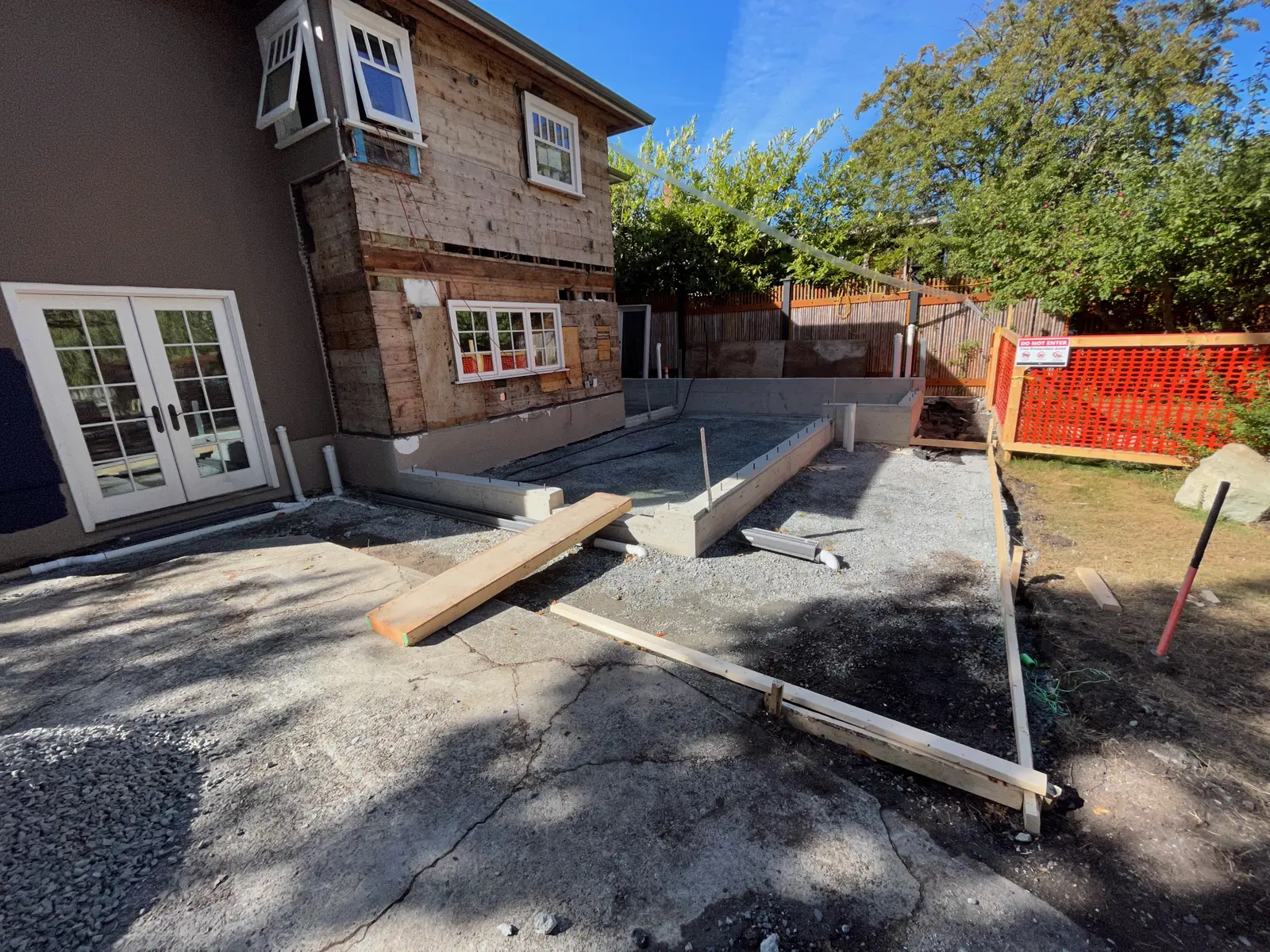 Exterior wall stripped back with new concrete work below