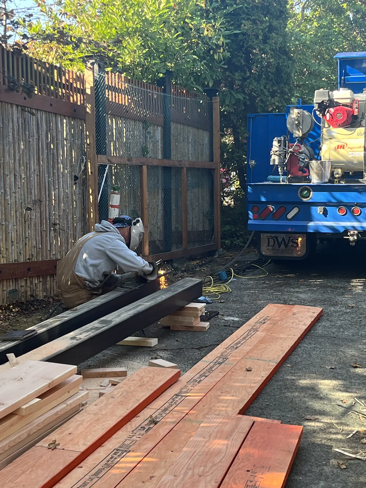 Worker cutting framing lumber on site