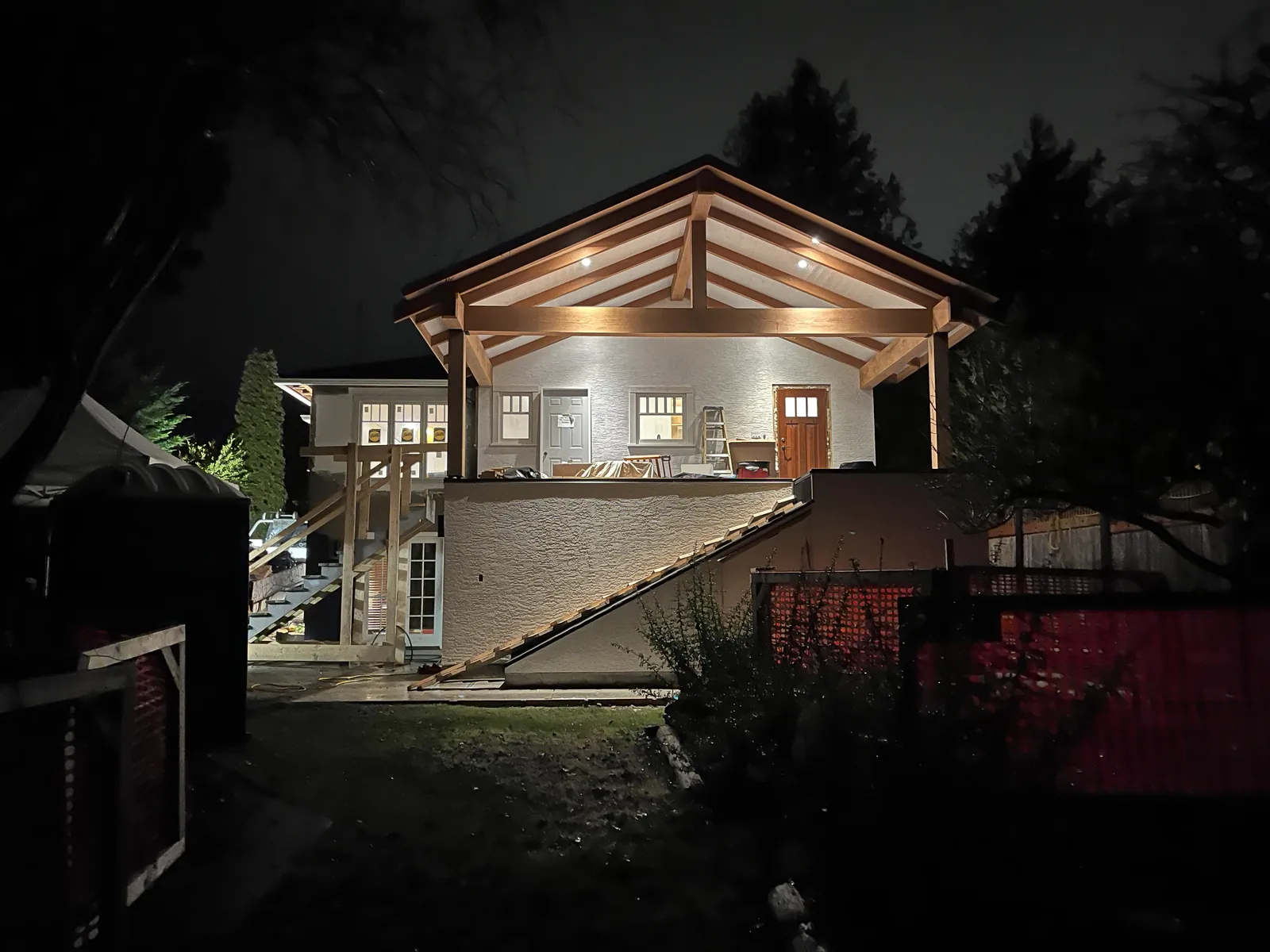 Timber frame home lit from inside at dusk