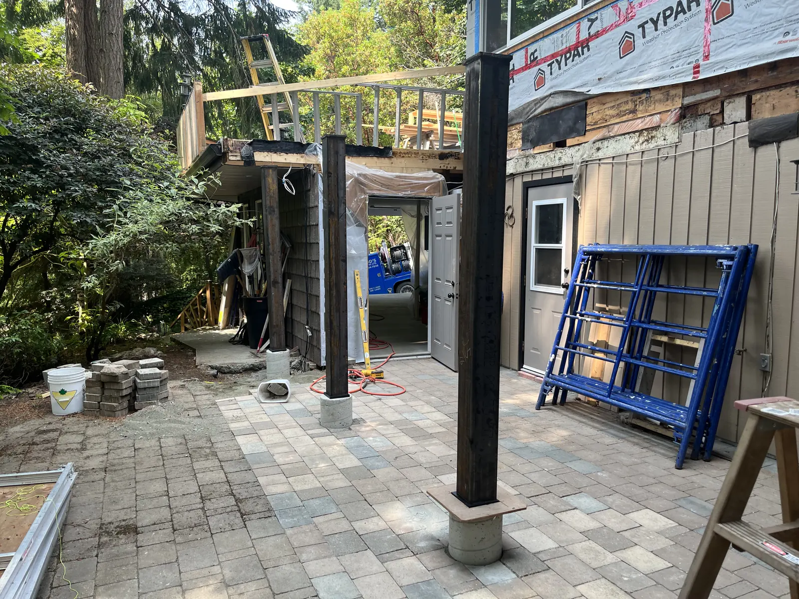 Covered patio with steel posts under construction