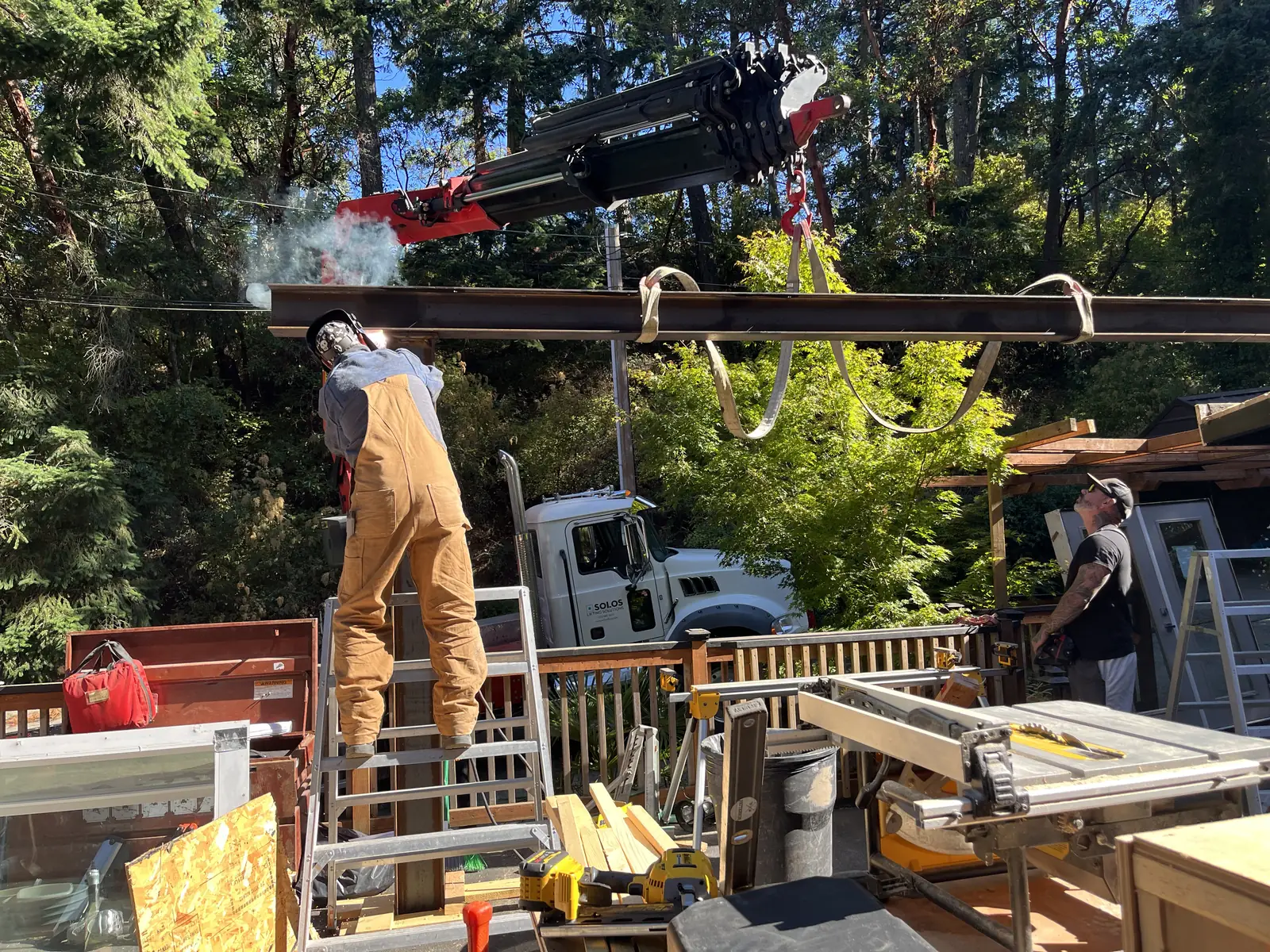 Crew setting a heavy timber beam in place