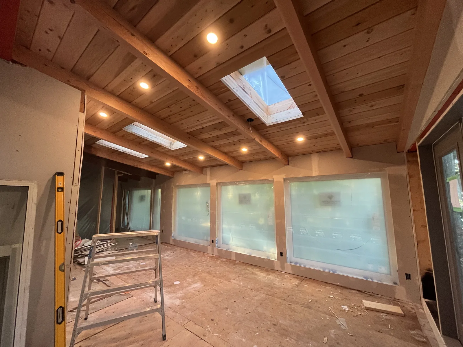 Cedar ceiling with exposed beams and skylights in a new build