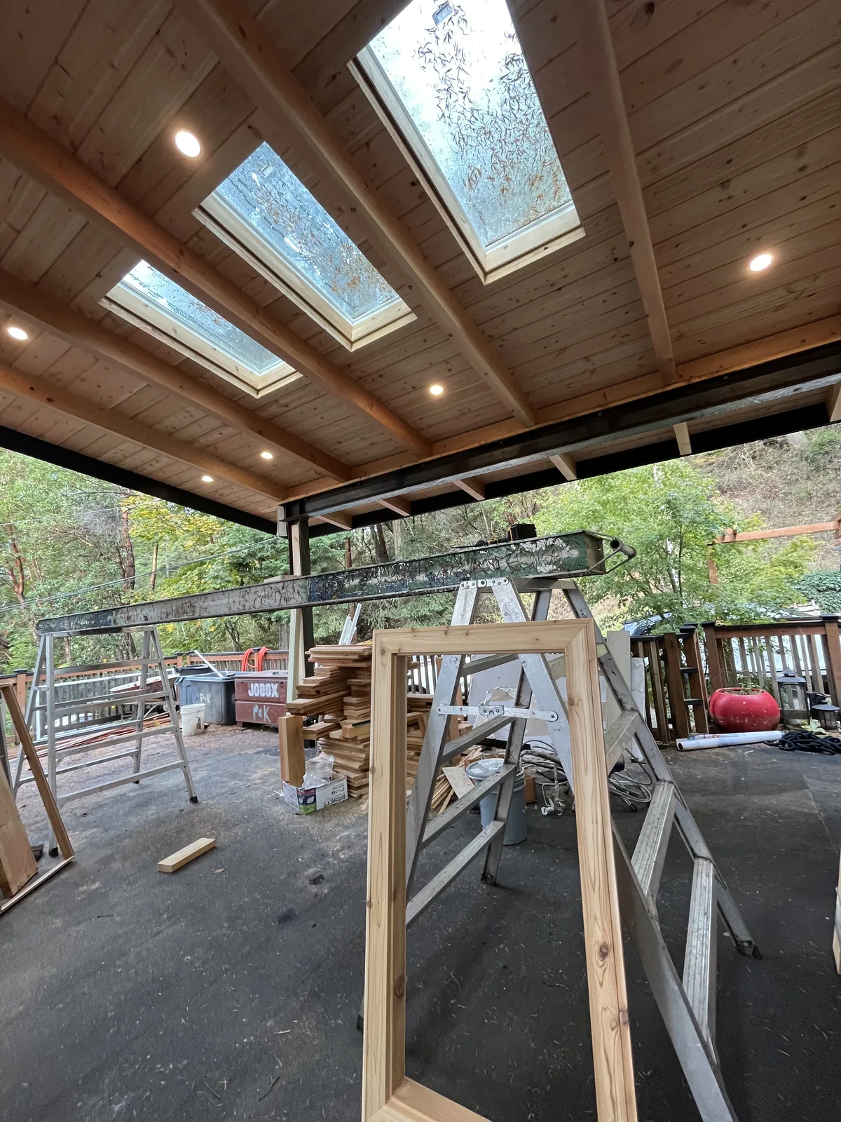 Timber frame roof with skylights over a new deck