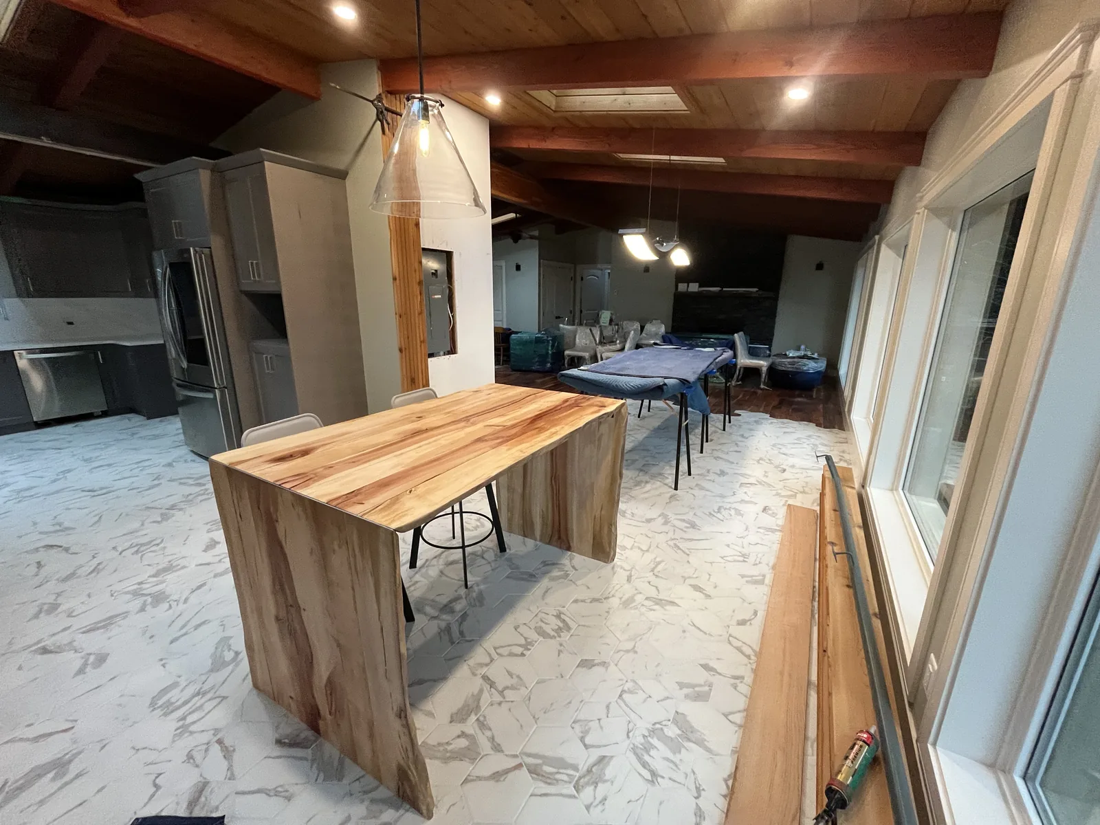 Kitchen with a live edge island and a cedar ceiling under construction