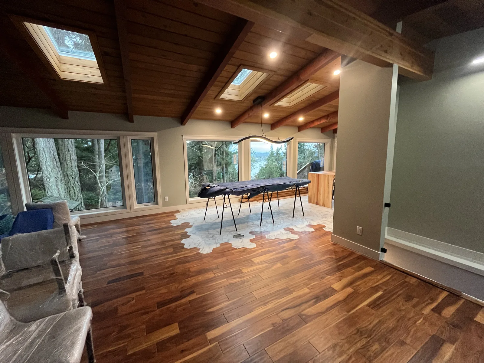 Room with a cedar ceiling, skylights and a new hardwood floor