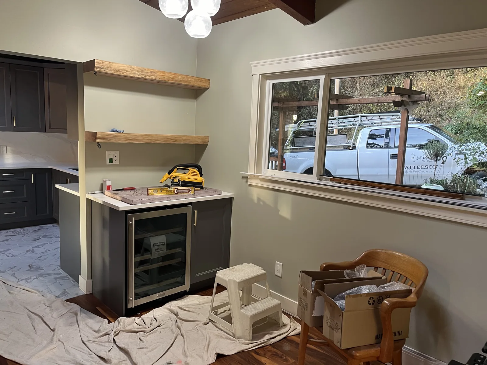 Kitchen under construction with an island and a protected floor