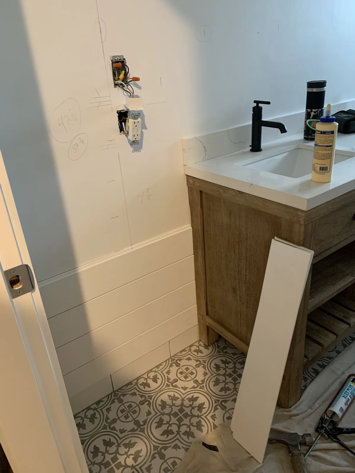 Bathroom vanity and tiled floor during finishing