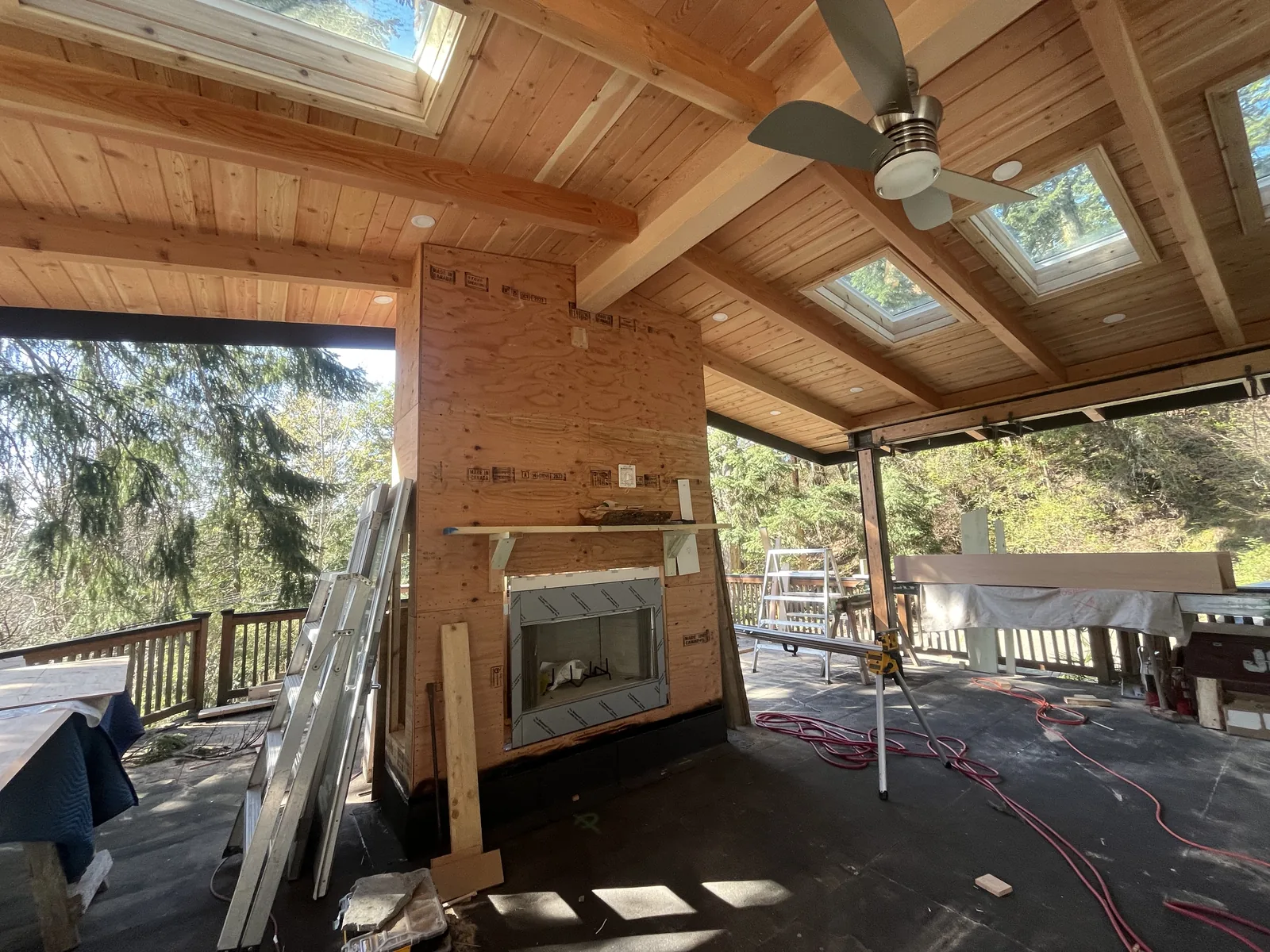 Cedar clad wall and timber ceiling in a room under construction