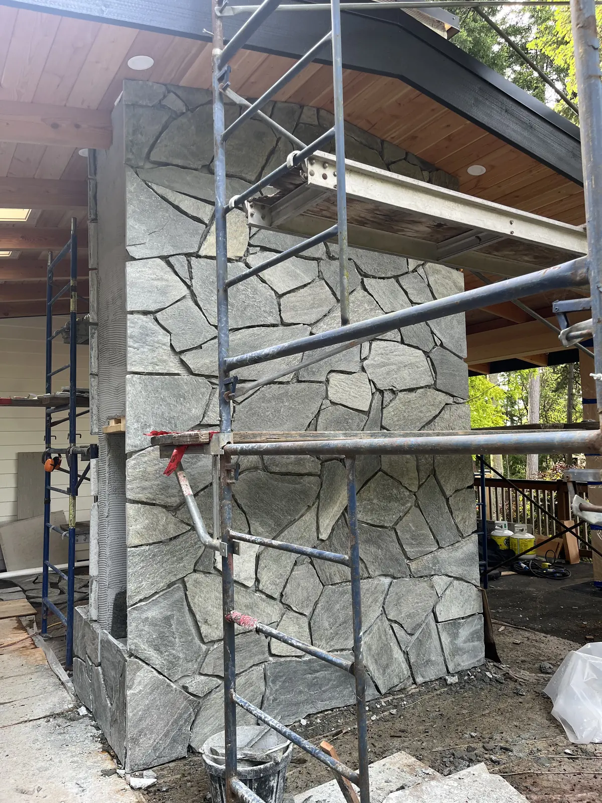 Stone chimney and scaffolding on a new build
