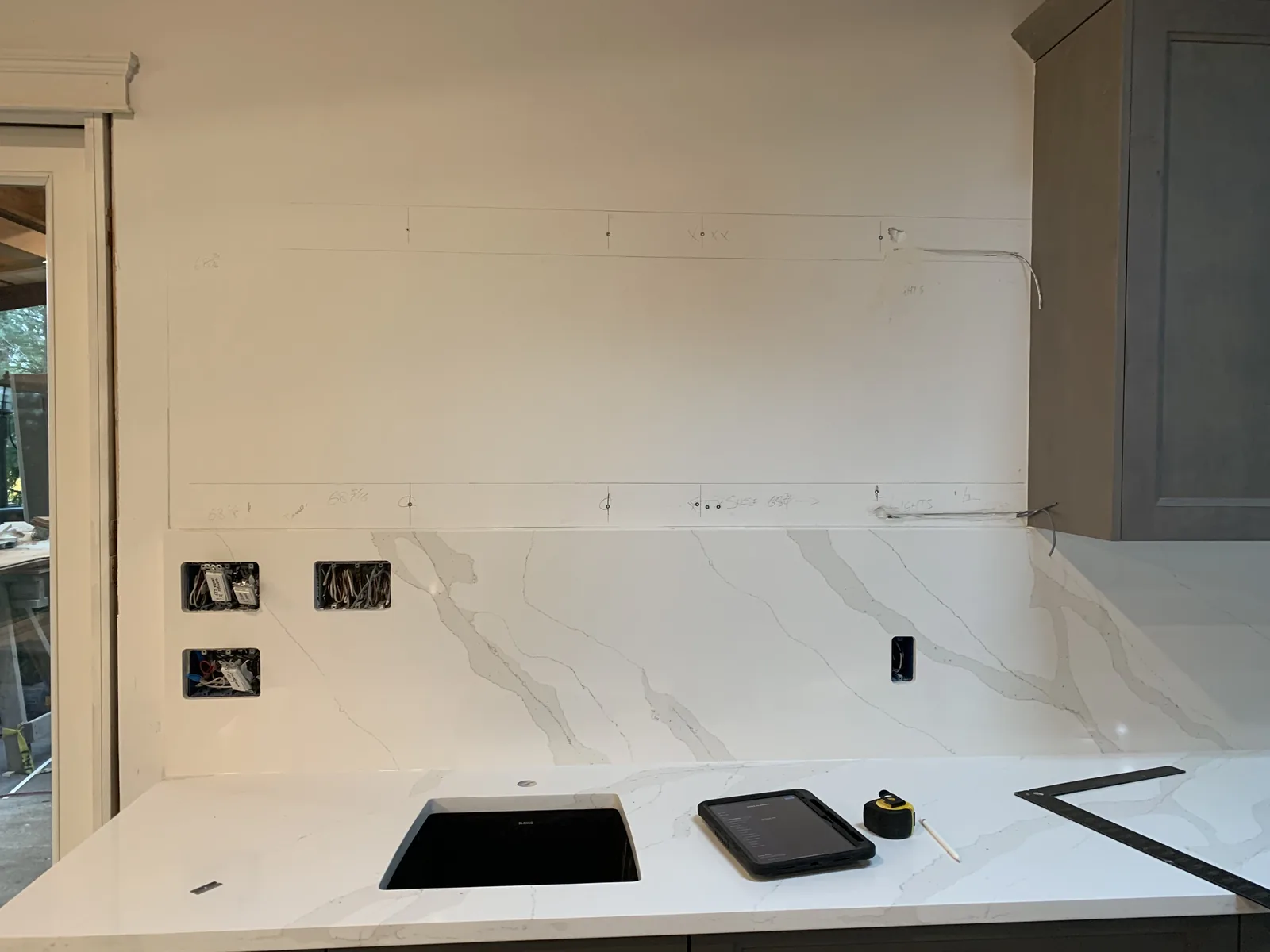 White countertop with a cooktop being installed