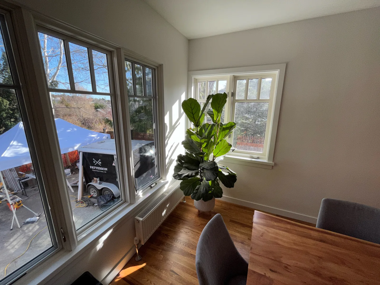 Dining area with large new windows and hardwood flooring