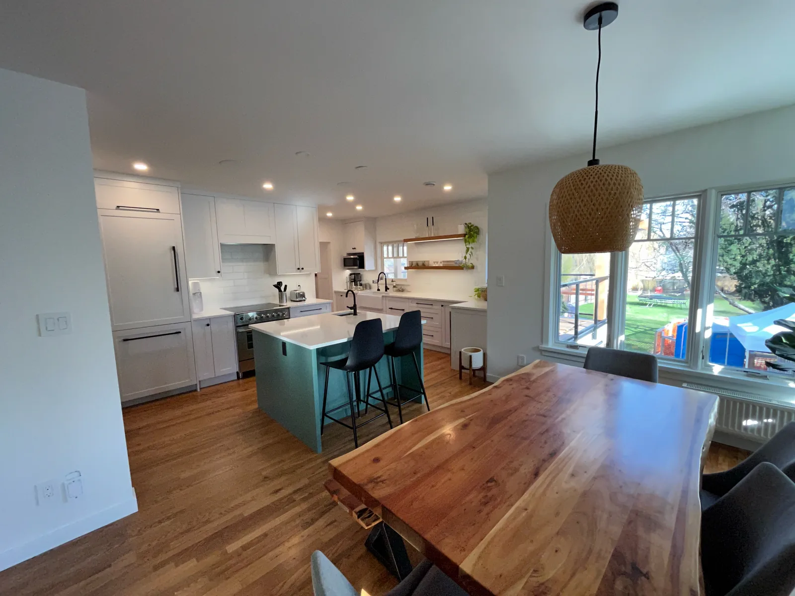 Open plan kitchen and dining area with a live edge wood table