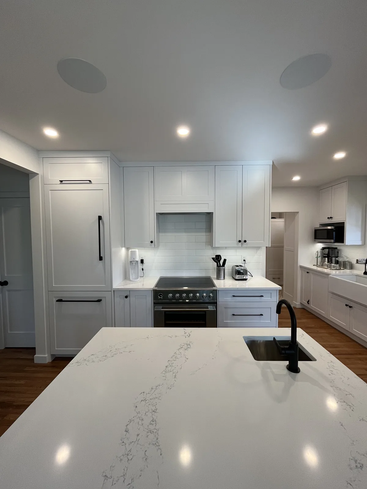 Kitchen island with a white marble countertop and an undermount sink