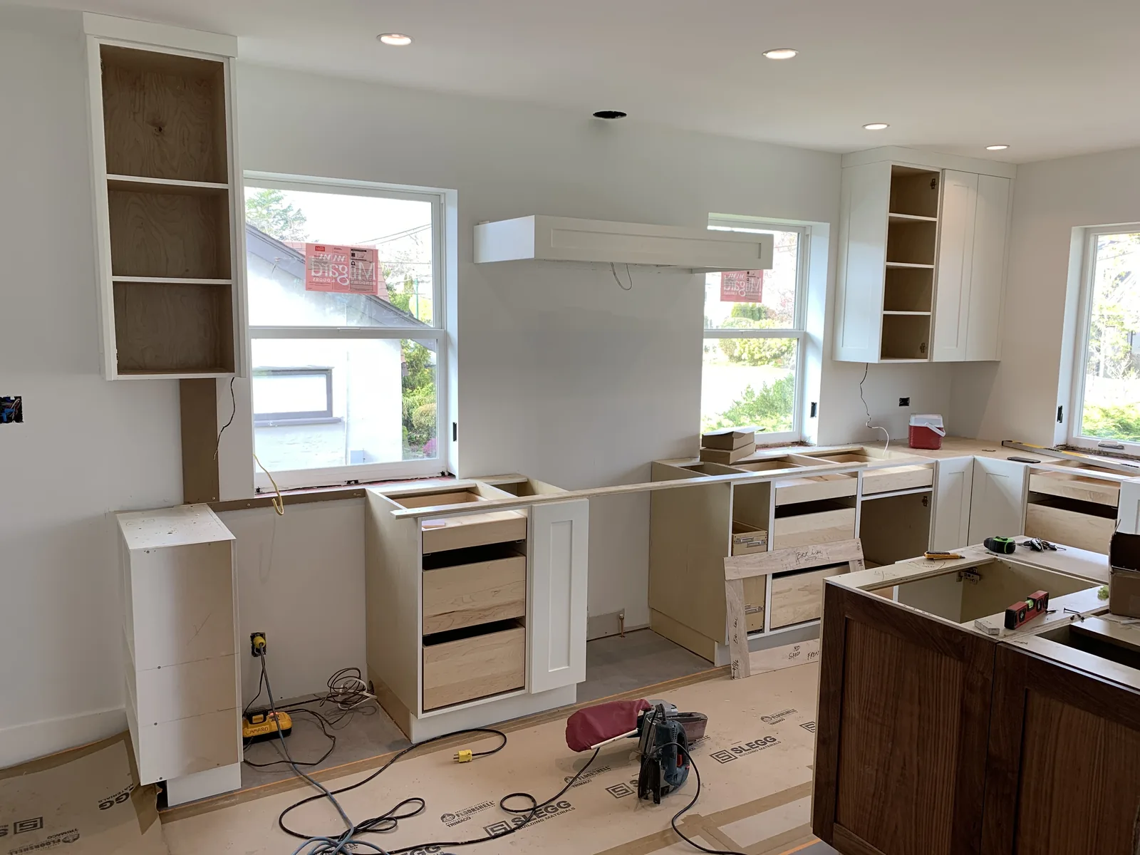 Cabinet boxes and shelving set in place during a kitchen installation