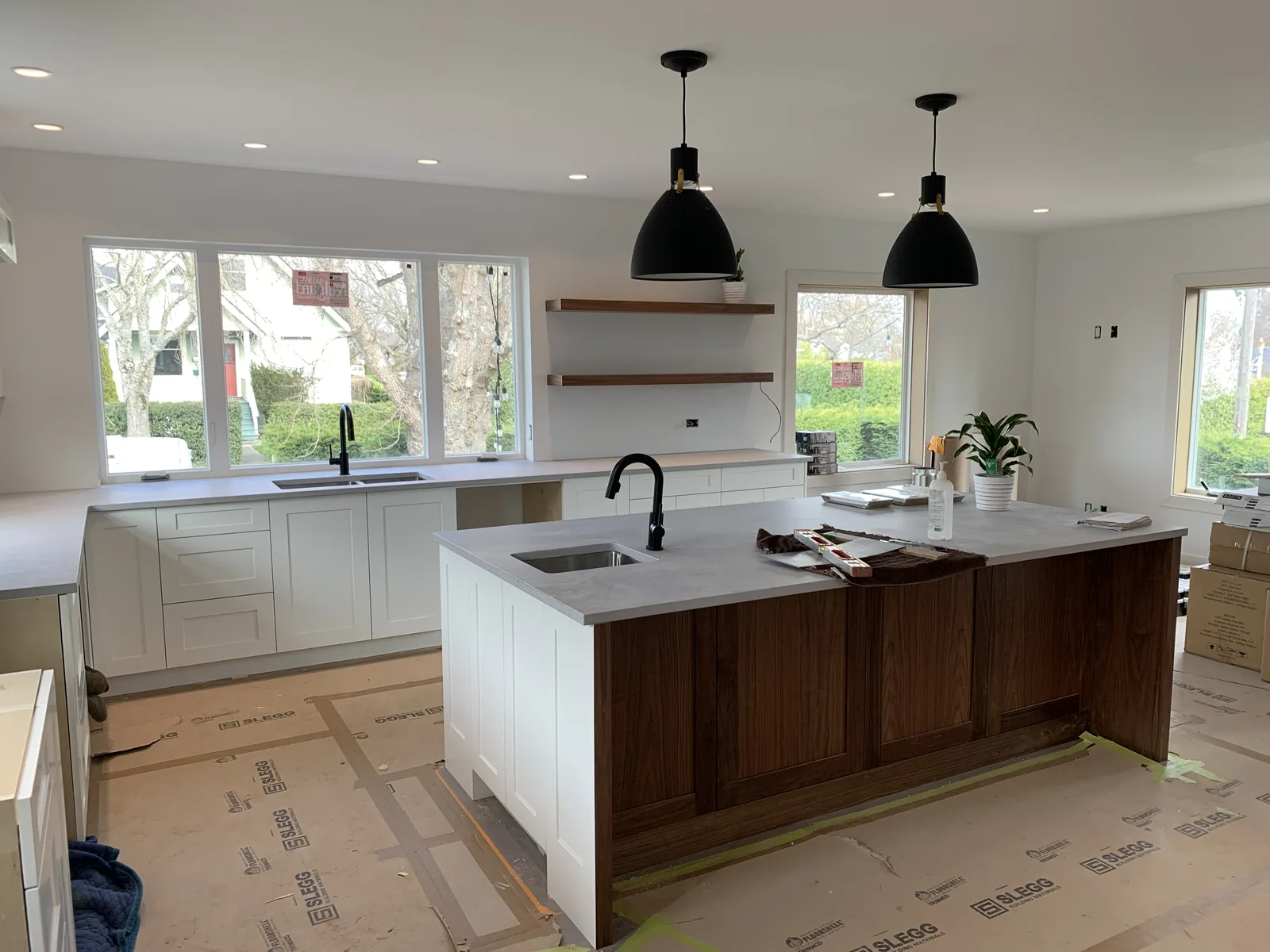 White kitchen with black pendant lights over the island