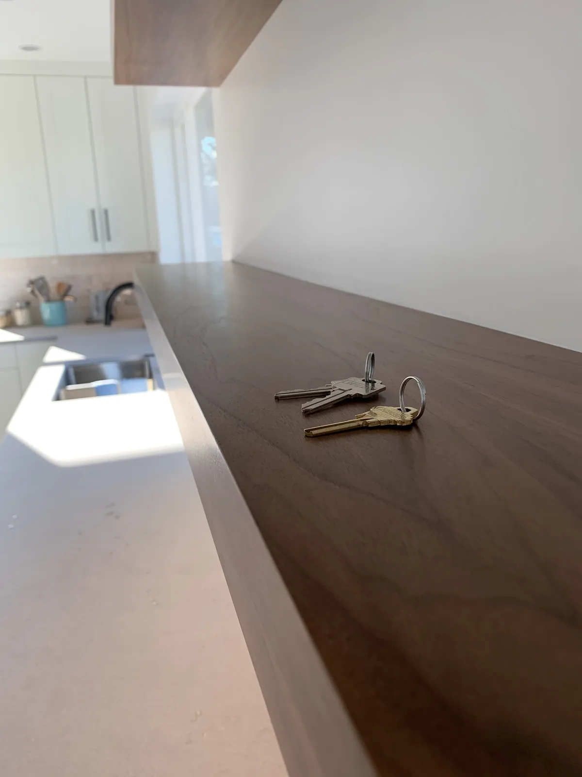 Walnut countertop with a waterfall end beside a window