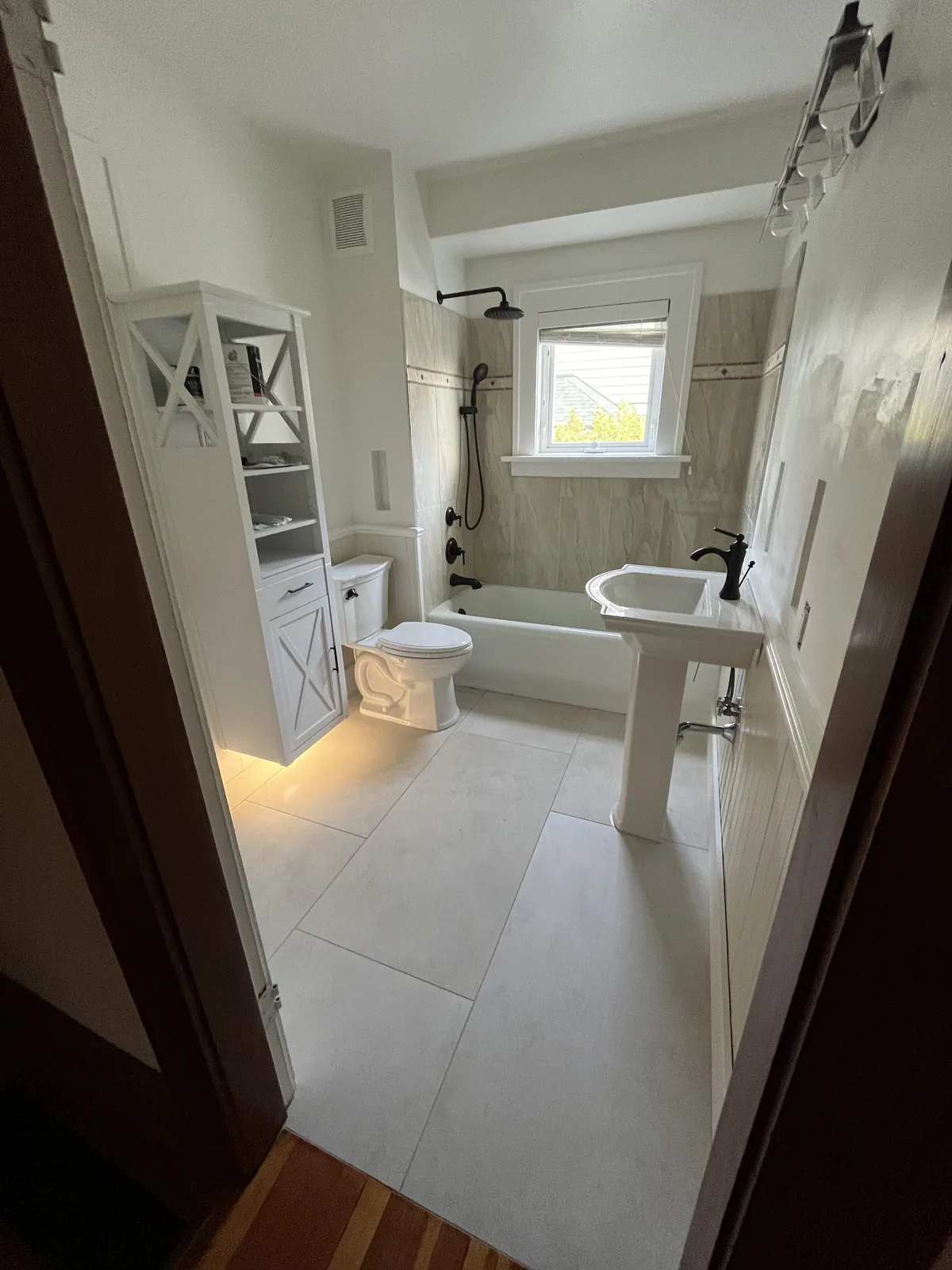 Bathroom with a freestanding tub and tiled walls