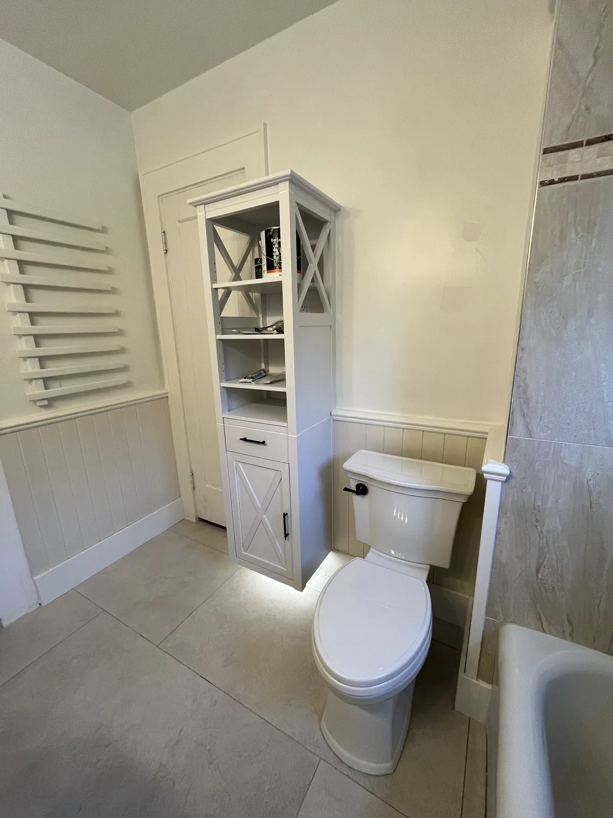 Bathroom with interior shutters and tiled flooring