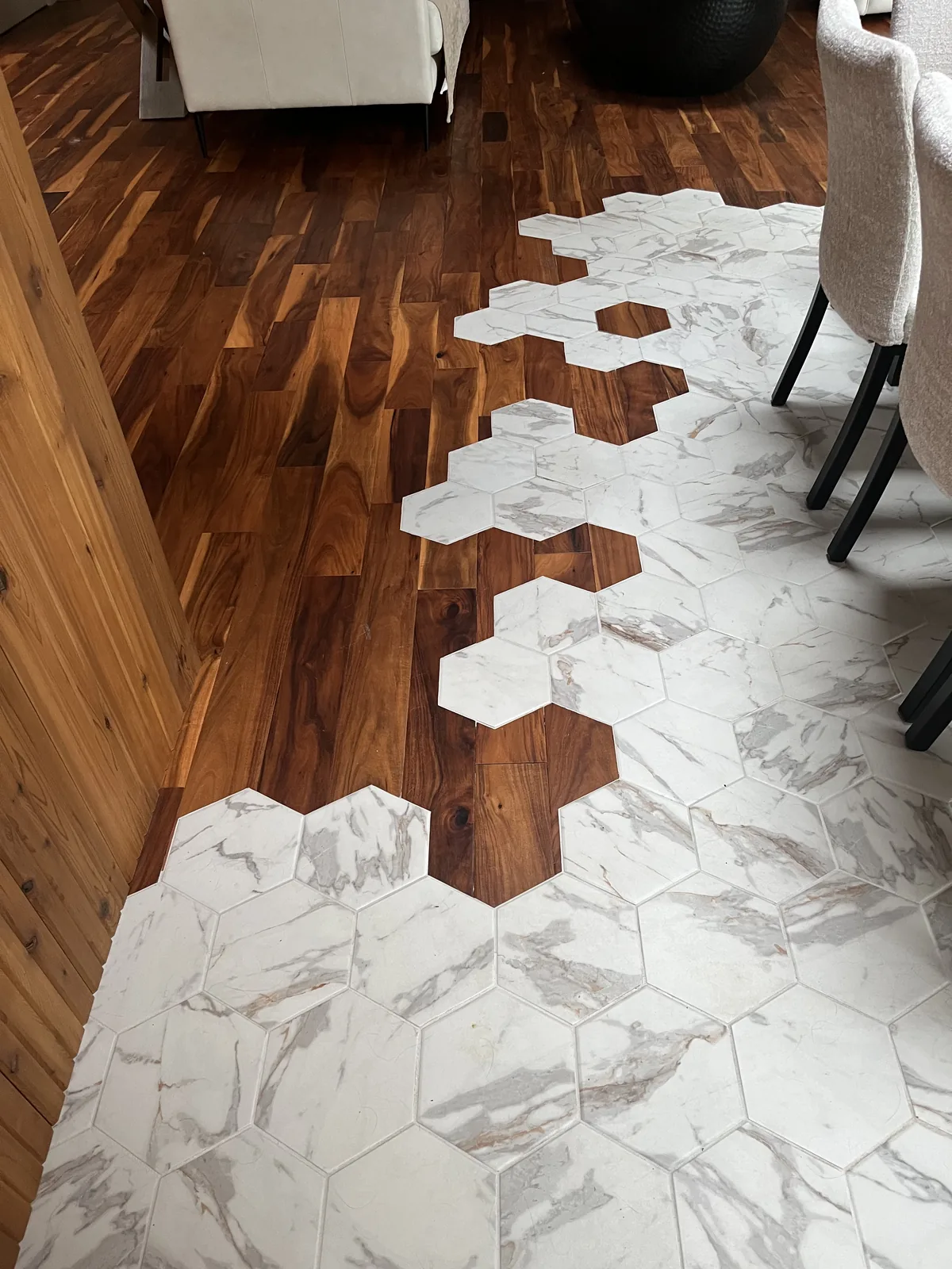 Hexagonal marble tile set into a hardwood floor