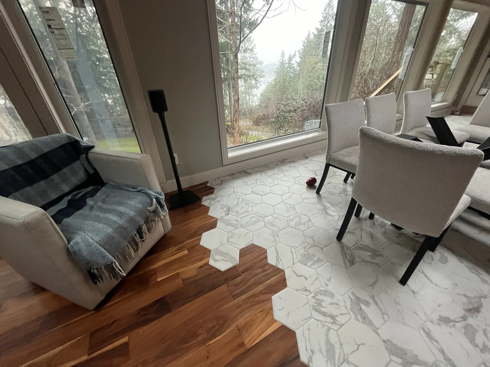 Living space where a marble tile floor meets hardwood