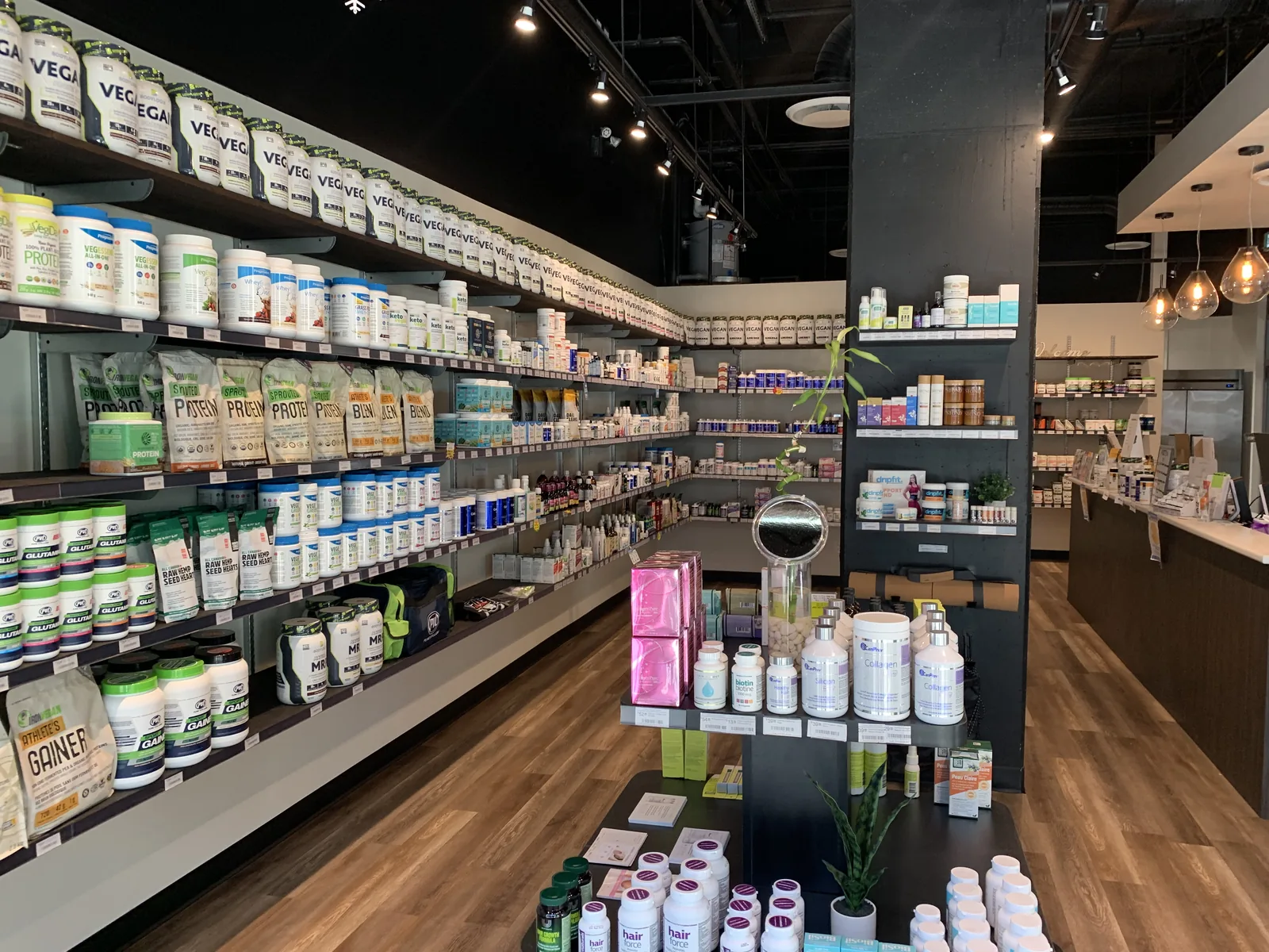 Retail shelving stocked with supplements along a timber floor aisle at Fuel SVN