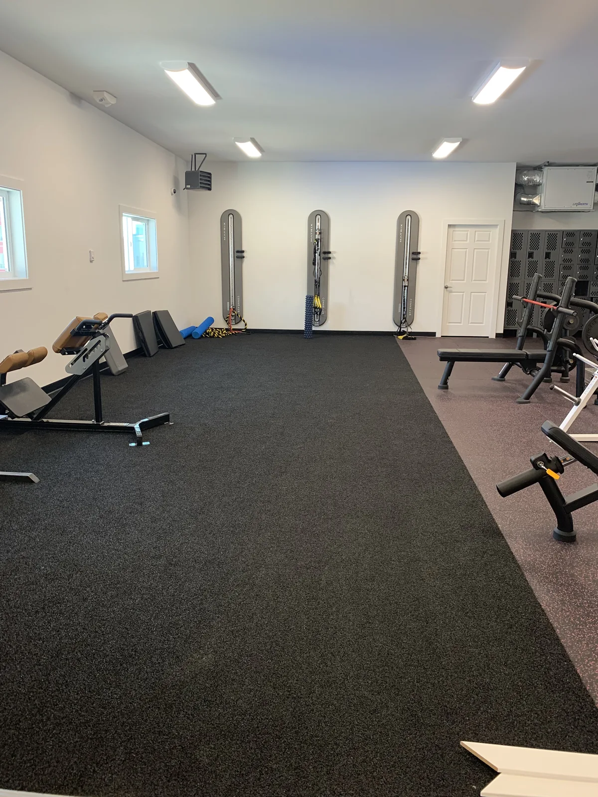 Open rubber floored training area with benches along the wall at Truth Gym Victoria