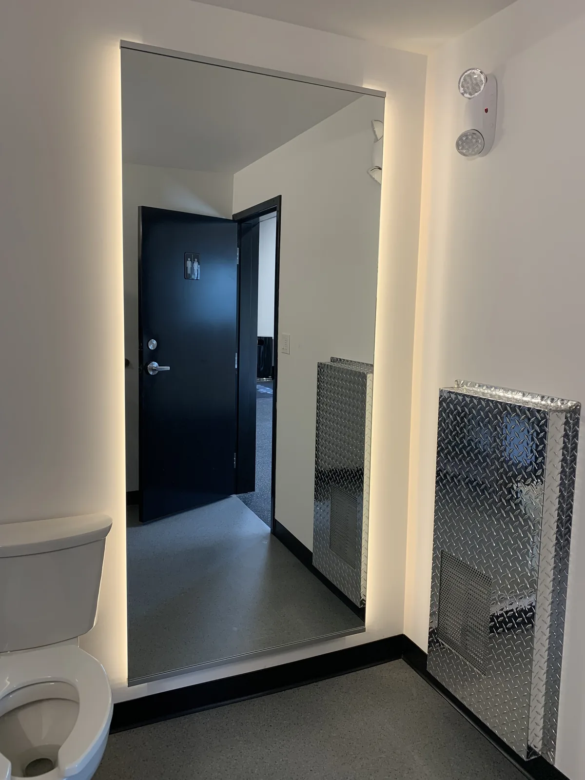 Entry corridor with lockers and a black framed door at Truth Gym Victoria